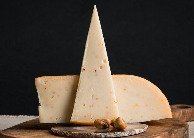 This is a picture of Marieke Garlic & Onion Gouda cheese, offered by Fromagination