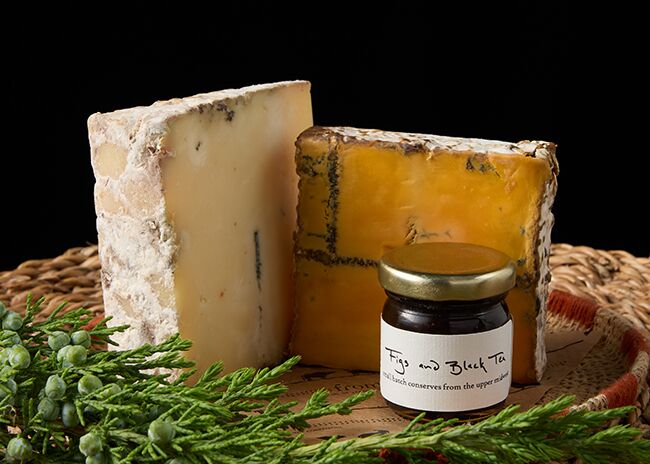 This is a picture of Roelli Cheese Haus' Dunbarton Blue and Red Rock cheeses, offered by Fromagination.