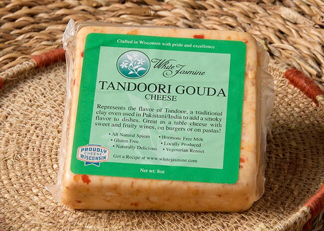 This is a picture of White Jasmine Tandoori Gouda cheese, offered by Fromagination.